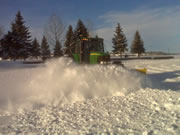 Tractor and Blade Removing Snow